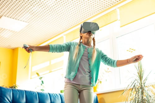 Preview: Enthusiastic schoolgirl being wrapped up in virtual reality