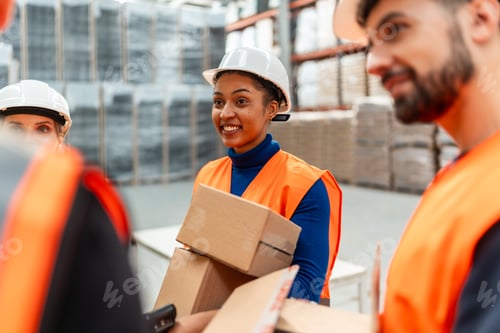 Preview: Warehouse workers collaborating picking orders for shipping
