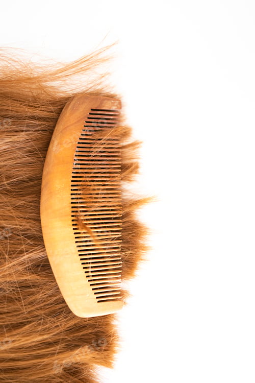 Preview: A wooden comb on a brown long shiny synthetic extensions of synthetic brown hair wig