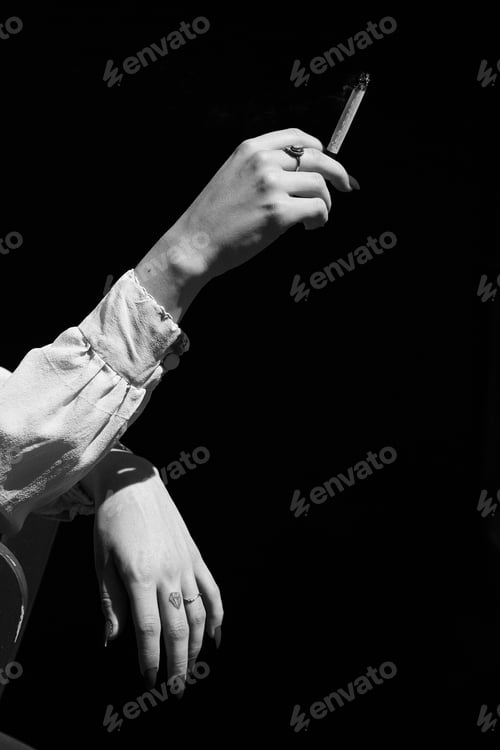 Preview: Woman's Hand Holding Marijuana THC CBD Joint in Black and White
