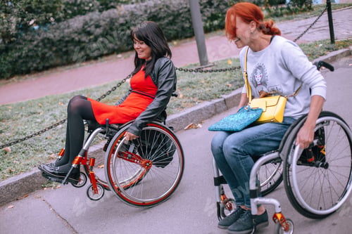 Preview: Wheelchair rolling downhill with a woman city dweller.