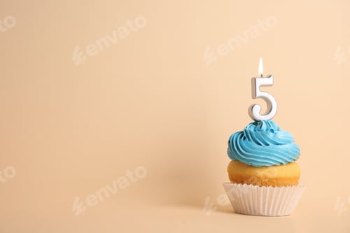 Preview: Birthday cupcake with number five candle on beige background, space for text