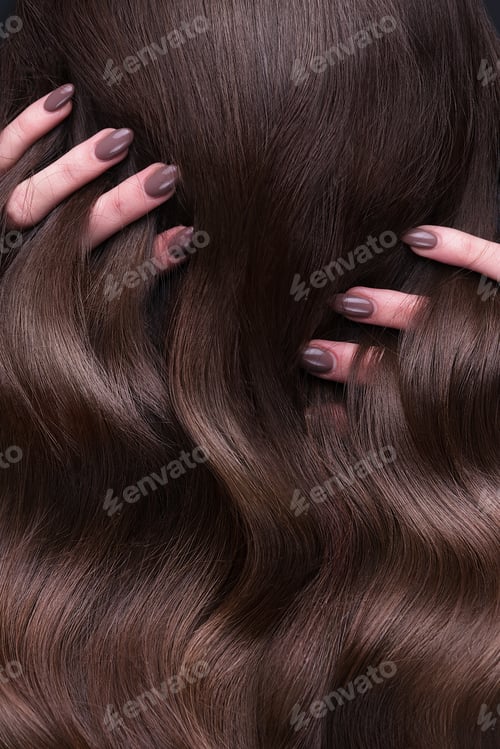Preview: A closeup view of a bunch of shiny curls brown hair
