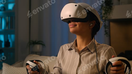 Preview: African American woman in VR helmet virtual reality glasses play modern metaverse video game