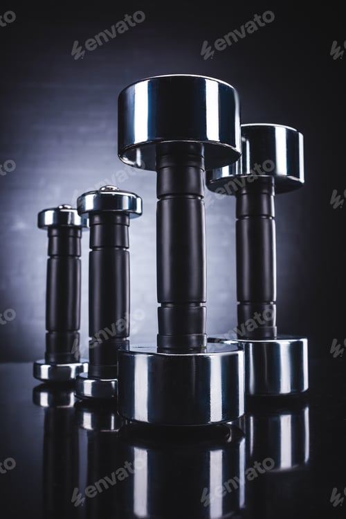 Preview: close-up view of shiny dumbbells, sport and healthy lifestyle concept