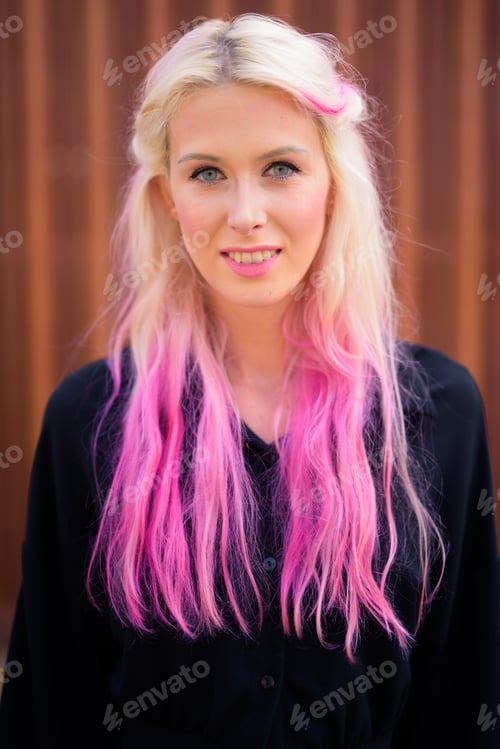 Preview: Happy young beautiful blonde woman in the streets outdoors