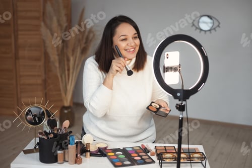 Preview: Makeup blogger plus size young beautiful woman broadcasts live on social media on smartphone