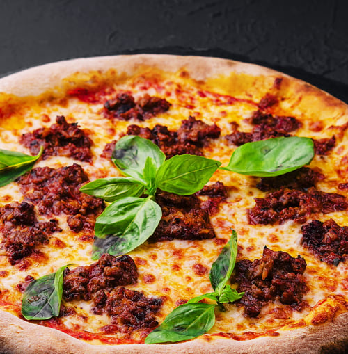 Preview: Pizza with minced meat and mozzarella on a stone board