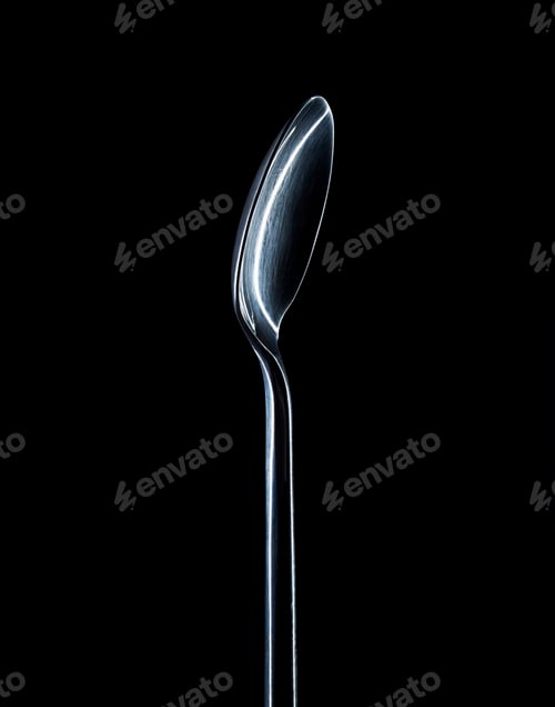 Preview: Close up of spoon isolated on black background