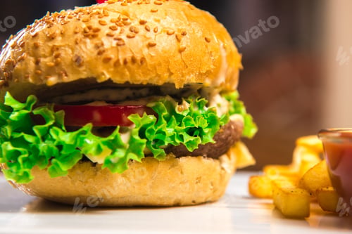 Preview: Hamburger with French fries on a wooden table