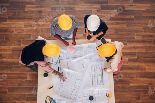 Preview: High angle shot of a multiracial team of architects having a meeting