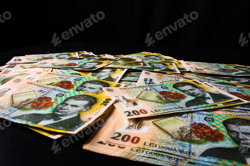 Preview: Closeup of the Romanian LEI bill pile spread on a black background