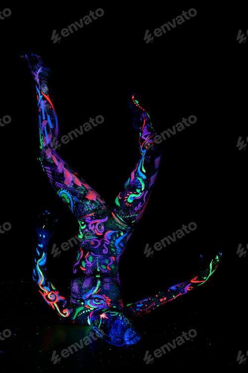 Preview: Art woman body dancing in ultraviolet light. Bright abstract drawings girl body neon color. Fashion