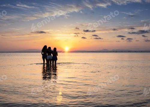 Preview: Women embracing on sunset at sea