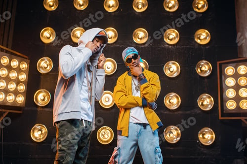 Preview: Two black rappers in caps on stage with spotlights