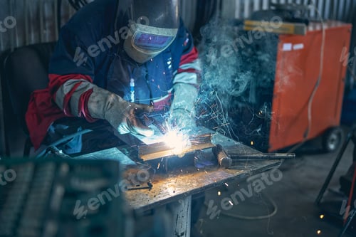 Preview: Attentive male person holding blowtorch in his hand