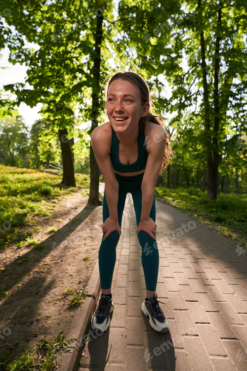 Preview: Happy sporty woman spending active day in park