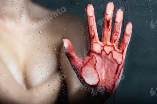 Preview: cropped view of nude girl with bleeding hand touching glass in bathroom