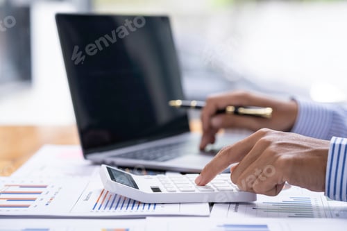 Preview: Accountant doing finance and calculate about cost on the desk at home office, close up hands of acco