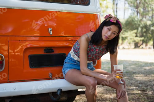 Preview: Woman sitting with a glass of beer in the park