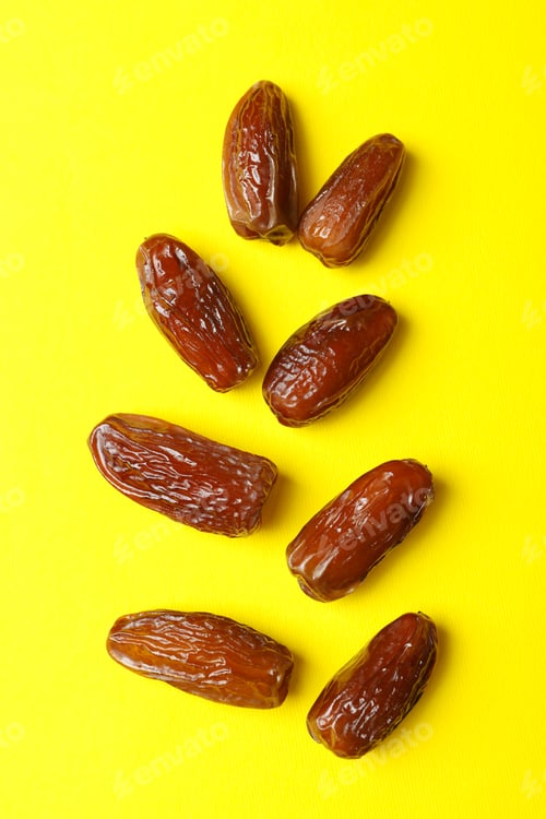 Preview: Tasty dried dates fruits on yellow background