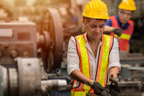 Preview: American black women teen worker working part time job as labor in industry factory with heavy steel