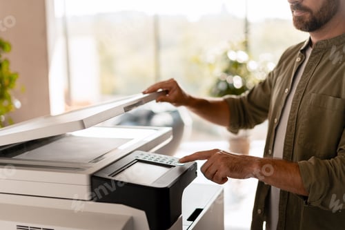 Preview: Office worker using a multifunction printer for scanning documents selective focus