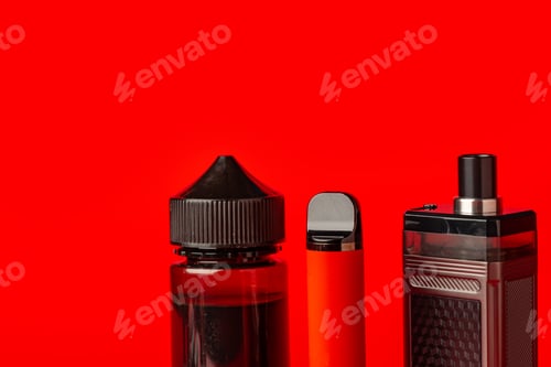 Preview: Disposable electronic cigarettes on red background close up