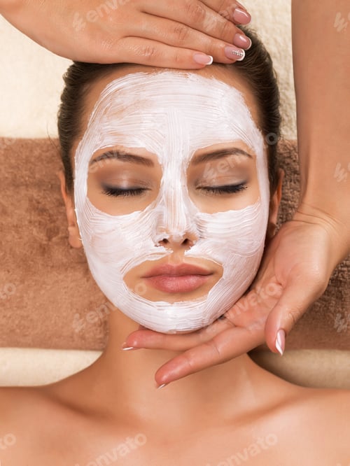 Preview: Woman with mask on her face having head massage.