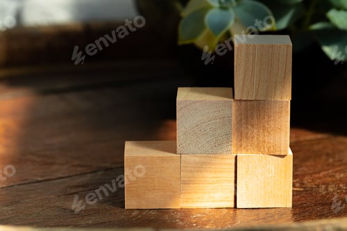 Preview: Groupped wooden square blocks on dark wooden table