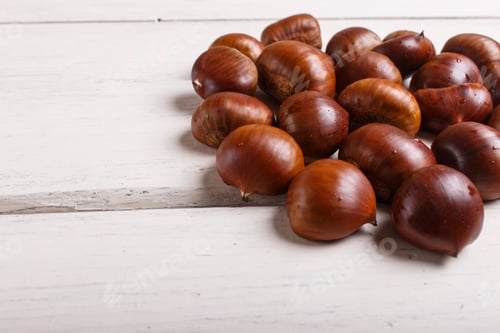 Preview: pile of sweet chestnuts on white wooden background