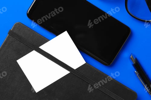 Preview: White businesscard with copy space on black notepad