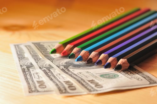 Preview: Photo of multi-colored pencils on the dollar bill