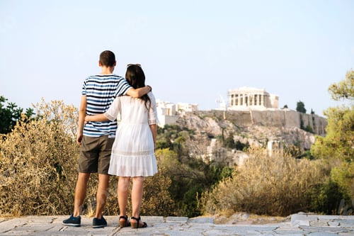 Preview: Greece, Athens, couple looking at The Acropolis and Parthenon from Areopagus
