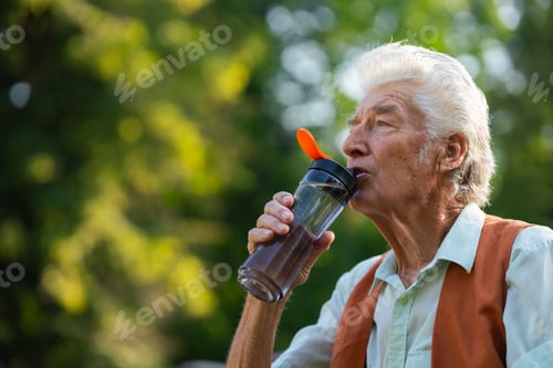 Preview: Senior man drinking water outdoor to better manage his diabetes.