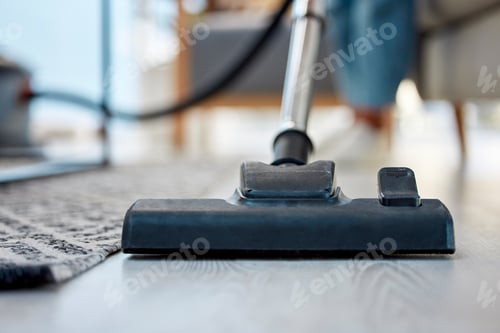 Preview: Vacuum cleaner, floor closeup and home living room for hygiene, spring cleaning and dust by blurred
