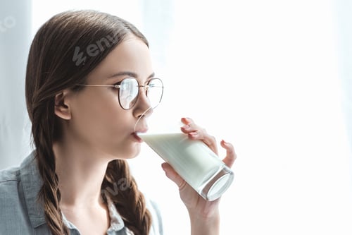 Preview: beautiful girl with braids drinking milk