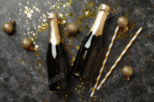 Preview: Champagne bottles, glitter and straws on black smokey background