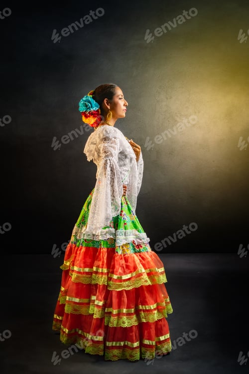Preview: A woman in a colorful dress stands in front of a wall