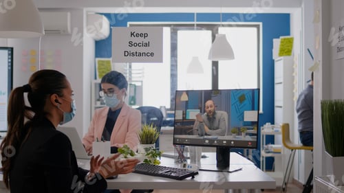 Preview: Coworkers wearing medical face masks to prevent infection with coronavirus