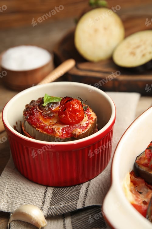 Preview: Baked eggplant with tomatoes, cheese and basil in ramekin on table