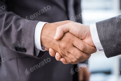 Preview: cropped view of businessmen shaking hands in office, business meeting concept