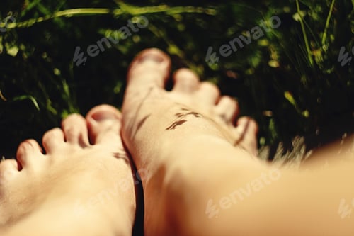 Preview: woman legs with flower and leaf, resting and relaxing in mountains, camping