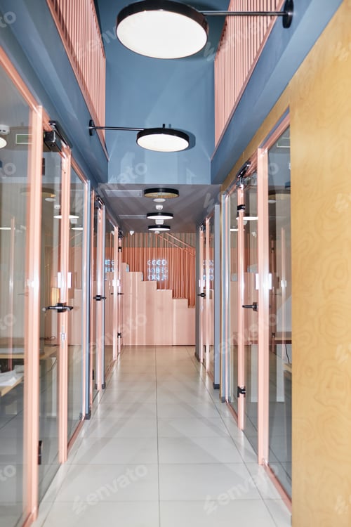 Preview: Corridor with Glass Doors Leading to Office Rooms in Business Center Designed with Pink Color