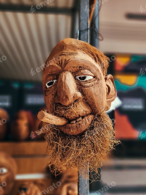 Preview: Close-up shot of a carved face sculpture of a bearded man