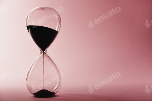 Preview: Hourglass on pink background, closeup. Urgency and running out of time concept