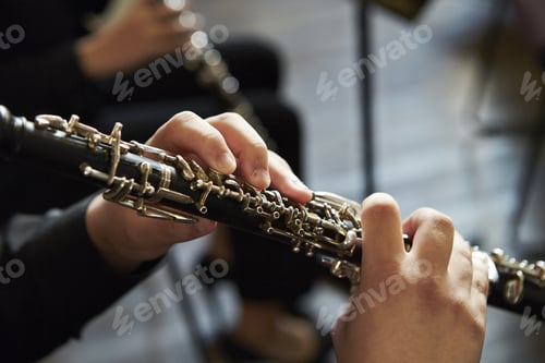 Preview: Closeup of a person playing the oboe, indoors