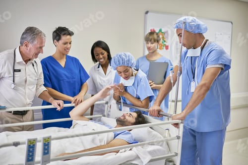 Preview: Doctors and nurses surrounding patient in hospital bed