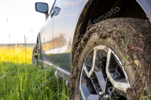 Preview: Close up of dirty off road car wheels with dirty tires covered with yellow mud
