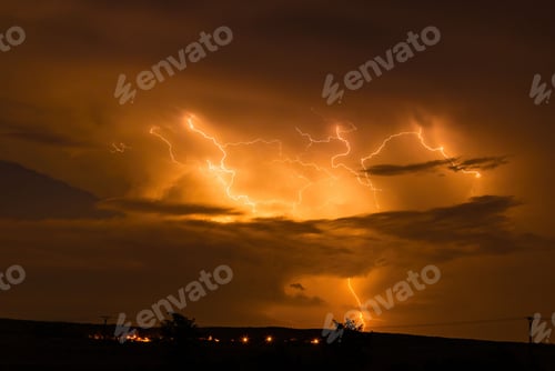 Preview: Lightning bolts illuminate the night sky during a thunderstorm.